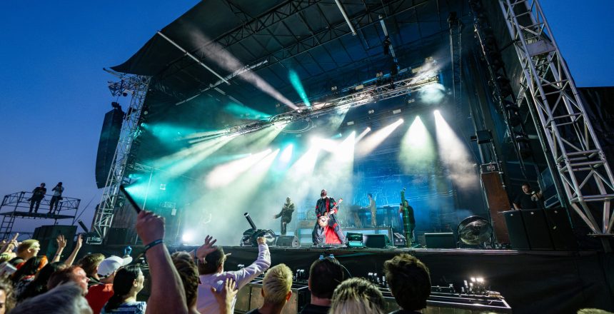 Band optræder på scenen foran et begejstret publikum til koncert på Skive Festival på Strandtangen.